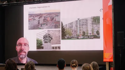 Vortrag über Zoom, zu sehen sind Impressionen von Chemnitz