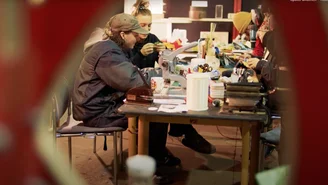 Several people working at a workbench
