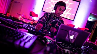 one person at a DJ booth