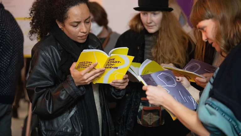 Three Women reading the magazine.