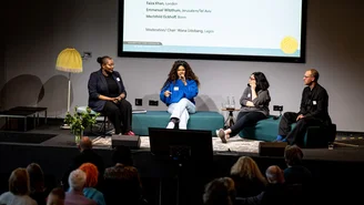 4 people sit on sofas on the stage