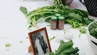 Foto: Pastaworkshop, eine Frau kocht mit grünem Gemüse.