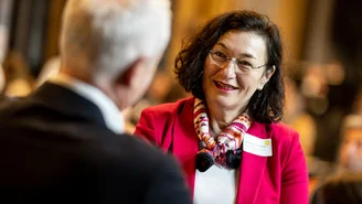 The back of a man's head talking to a smiling woman